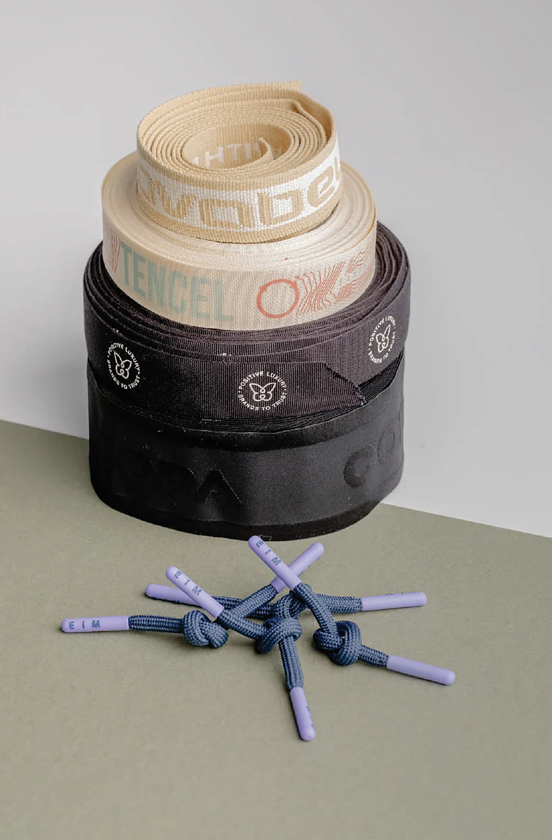 Rolls of recycled woven tapes and cords with printed cord ends